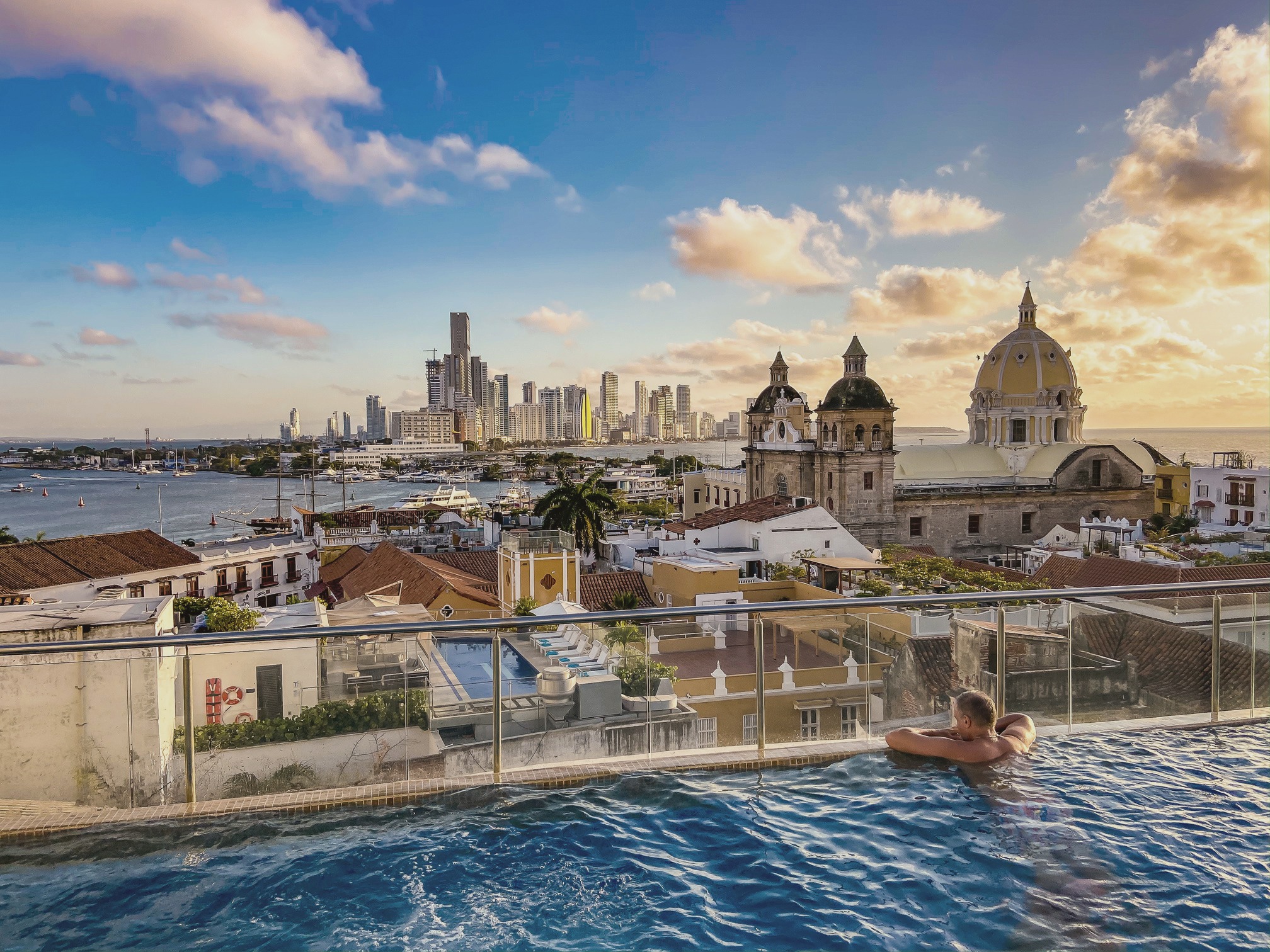A rooftop infinity pool over the old city of Cartagena at sunset