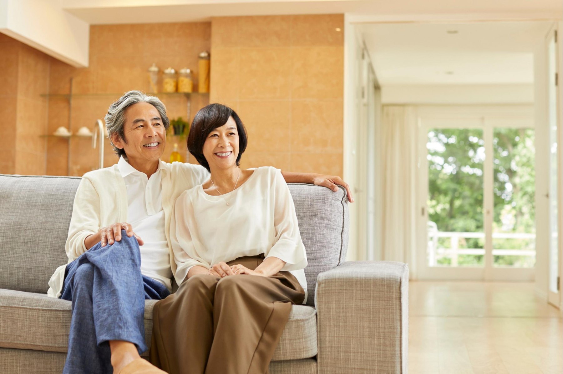 An older couple relaxing in a bright apartment